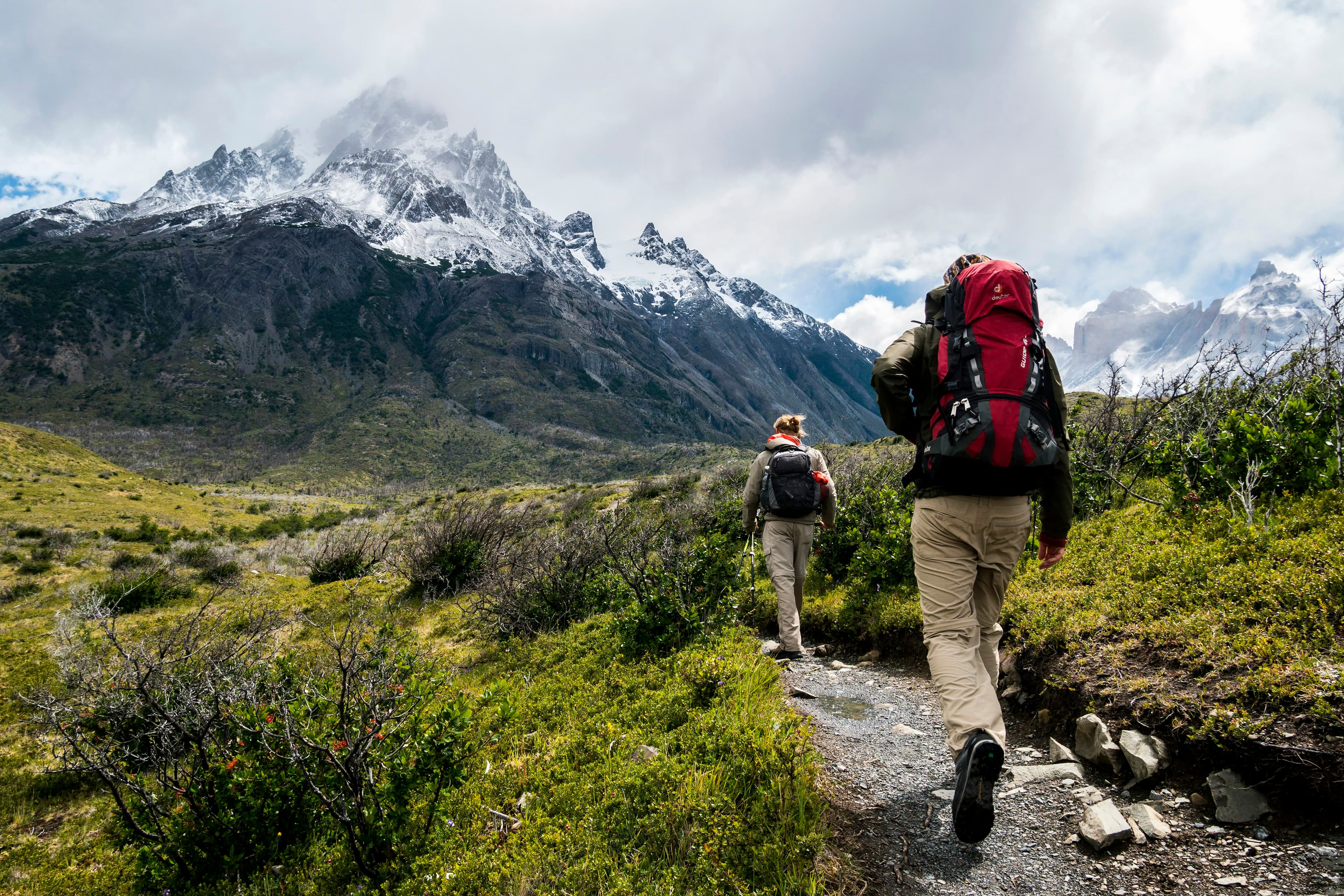 Hikers moving along a mountain ridge trail